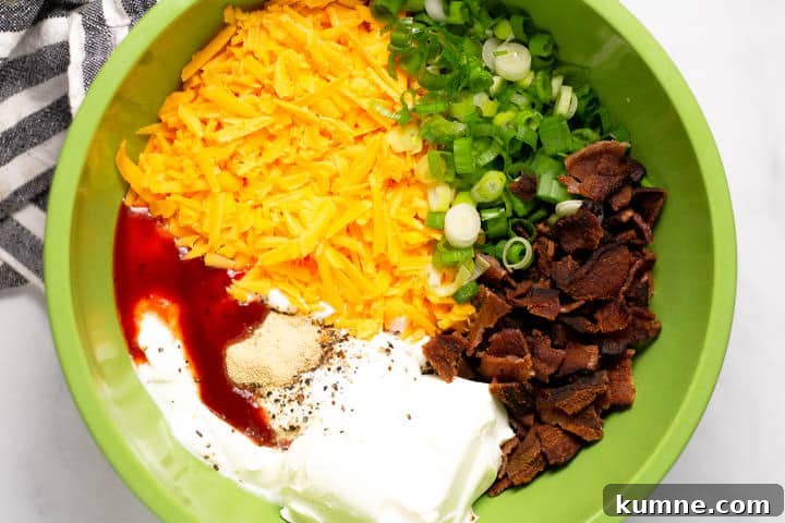 Loaded Baked Potato Dip Recipe for Parties and Game Day 4 Large green bowl filled with ingredients to make loaded baked potato dip