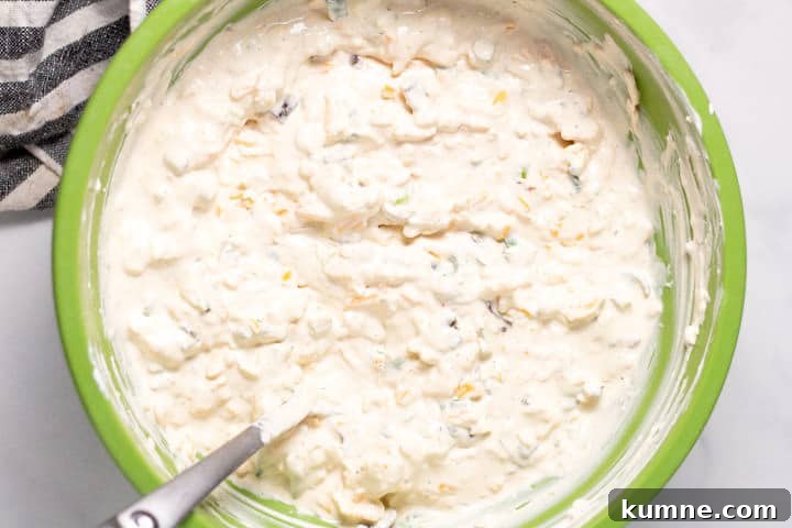 Loaded Baked Potato Dip Recipe for Parties and Game Day 5 Large green bowl filled with ingredients to make loaded baked potato dip