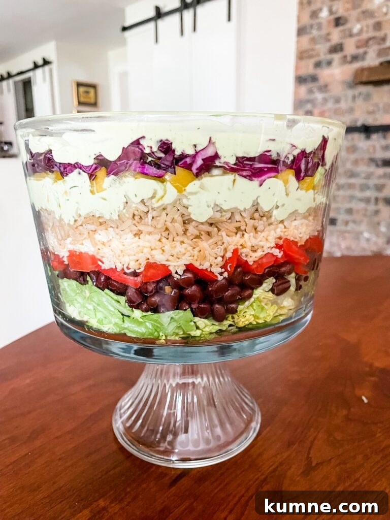5 Essential Hosting Tips to Impress Your Guests 7 The Vegetarian Layered Salad with Avocado and Lime Dressing served in a trifle dish