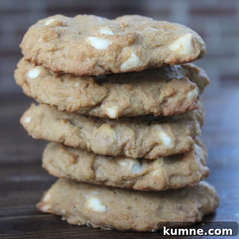 Top Fall Dessert Recipes You Need to Try This Season 18 Stack of White Chocolate Pumpkin Spice Cookies on a wood board
