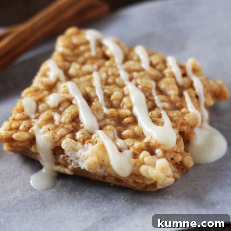 Top Fall Dessert Recipes You Need to Try This Season 19 Pumpkin spice rice krispie square on a piece of parchment