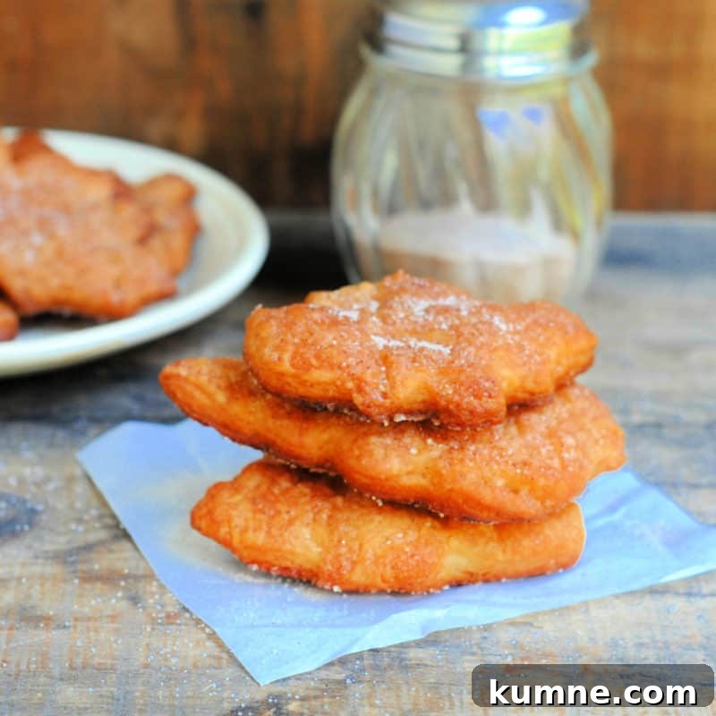 Top Fall Dessert Recipes You Need to Try This Season 22 Cinnamon And Sugar Crescents stacked on a paper napkin near a plate and sugar container