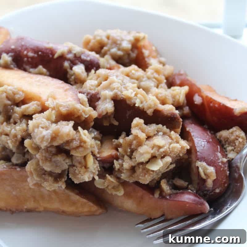 Top Fall Dessert Recipes You Need to Try This Season 31 Crock Pot Apple Crisp on a white plate with a fork