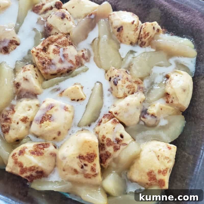 Top Fall Dessert Recipes You Need to Try This Season 8 2-Ingredient Cinnamon Roll Apple Cobbler in a glass baking dish