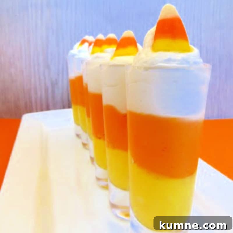 Top Fall Dessert Recipes You Need to Try This Season 10 Candy Corn Cheesecake Mousse in small glasses lined on a white platter
