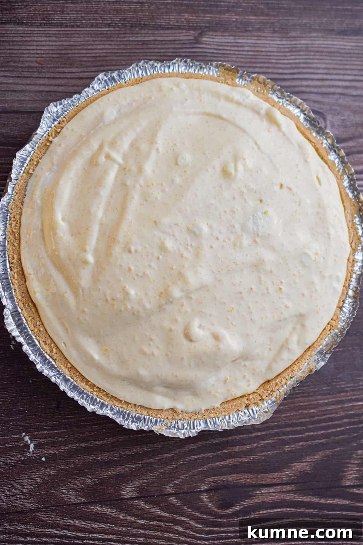 The mixture is poured into the graham cracker crust.