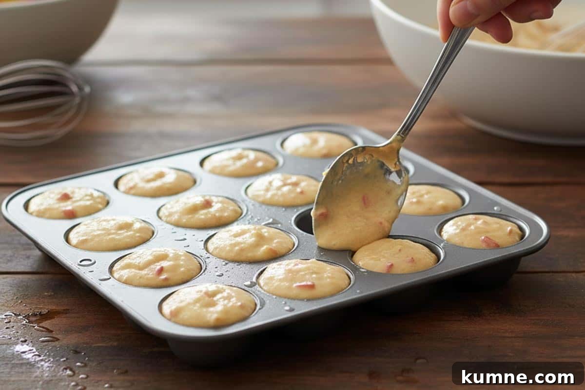 Maple-Glazed Apple Fritter Donut Holes Recipe 8 Filling the pan with the batter.