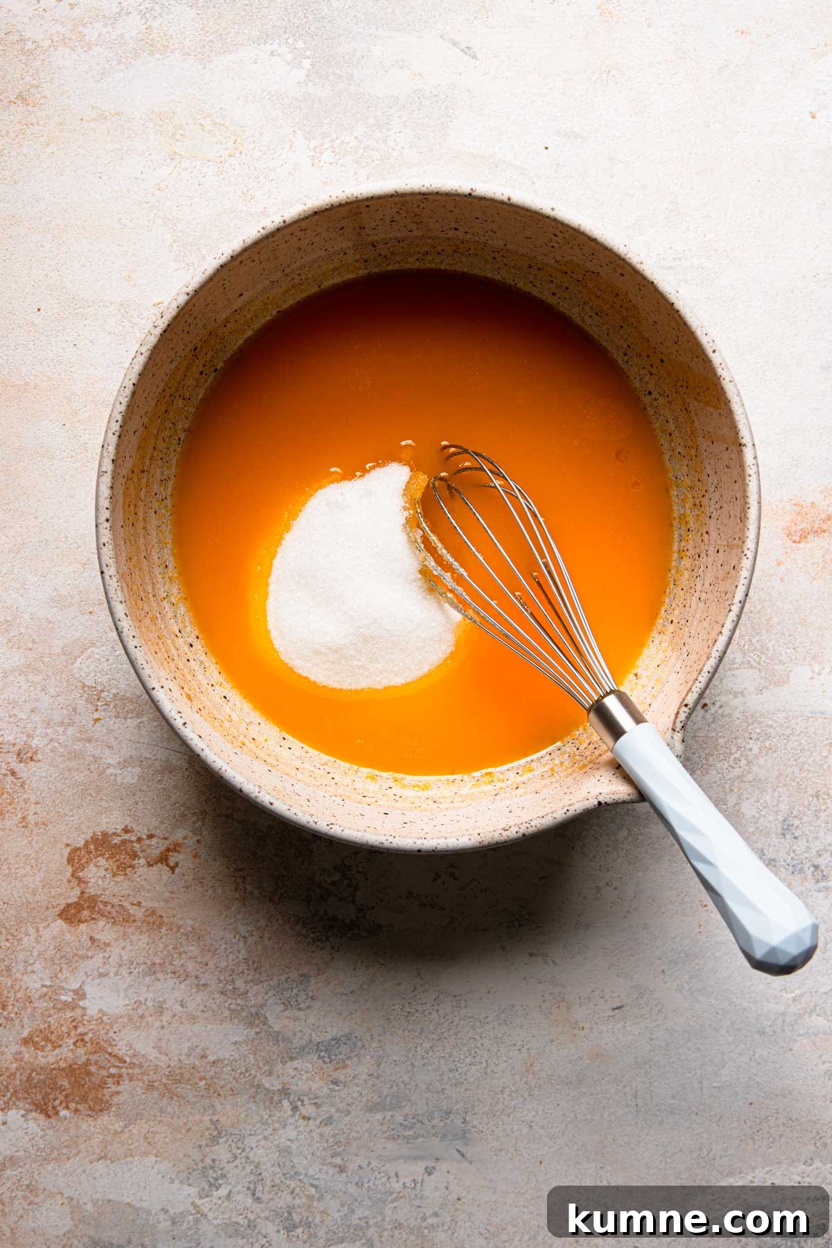 Light and Tender Passover Cake Recipe for a Perfect Seder 5 A large bowl with egg yolks mixture, sugar and a whisk.