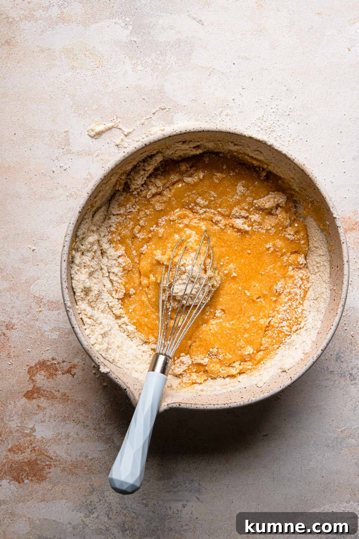 Light and Tender Passover Cake Recipe for a Perfect Seder 6 A large bowl with egg yolk mixture and a whisk mixing in almond flour.