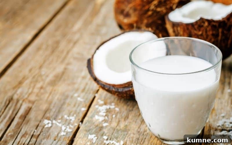 A glass of coconut cream on a wooden surface.