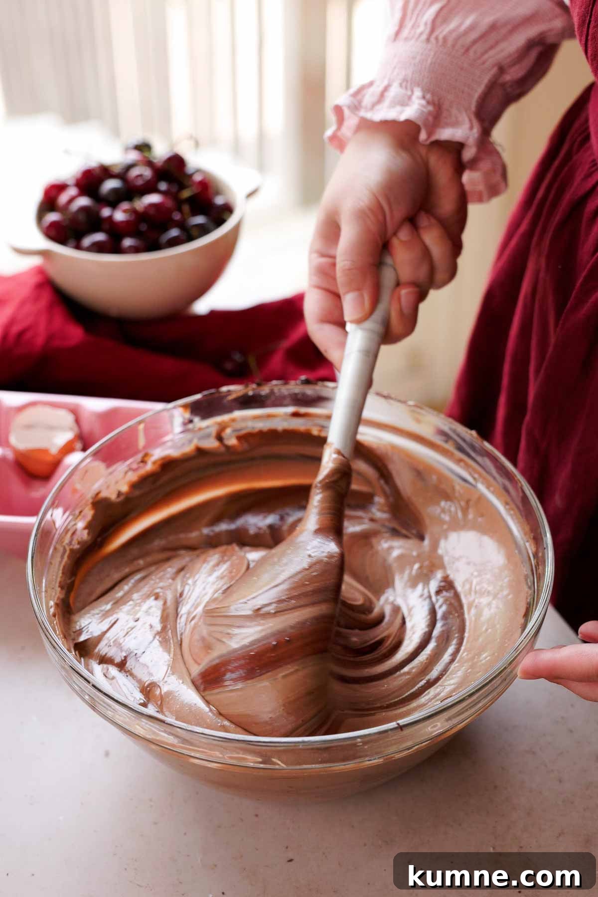 folding chocolate ganache into cheesecake batter