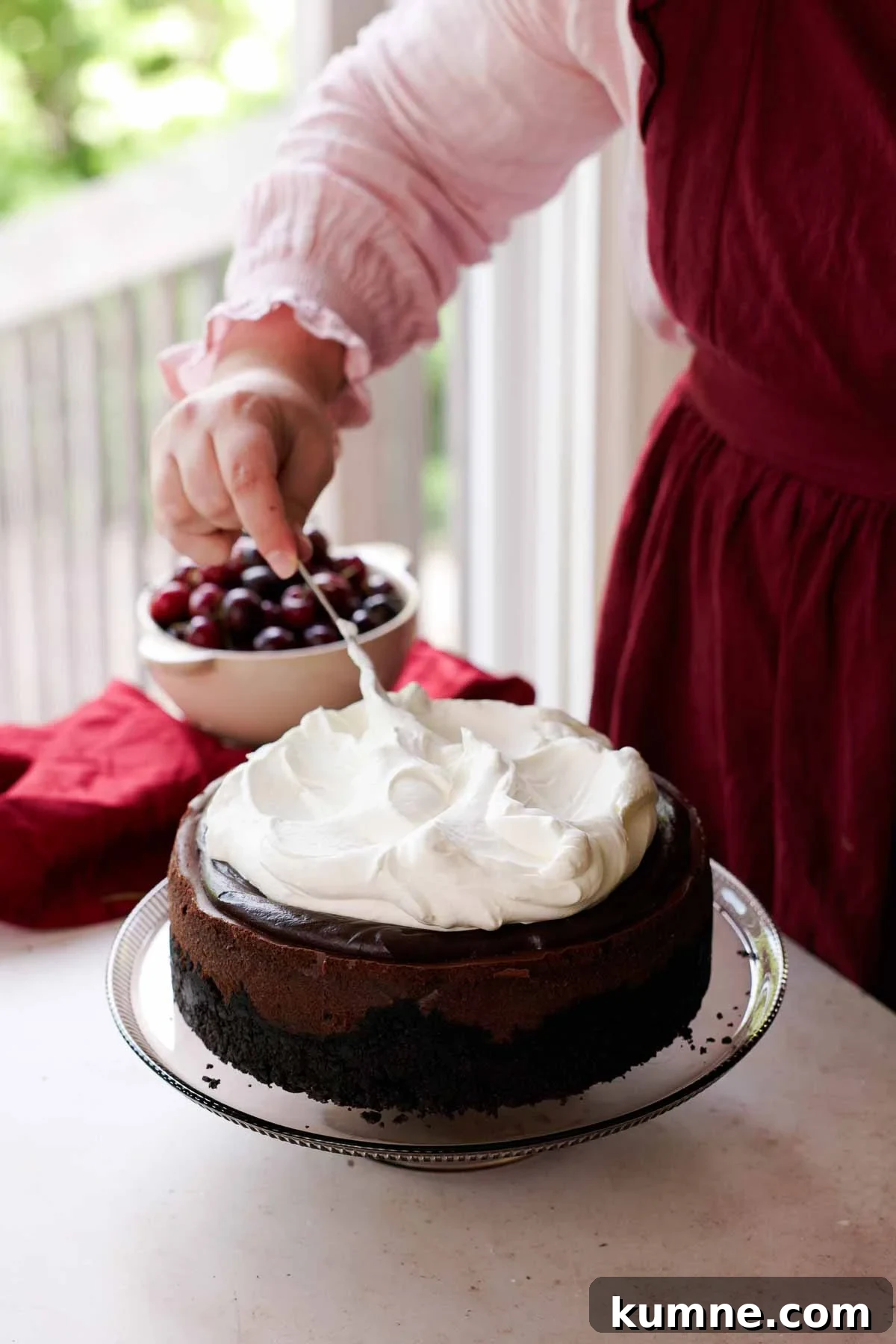 topping cheesecake with whipped cream
