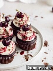 black forest cupcakes with a cherry on top on porcelain plate
