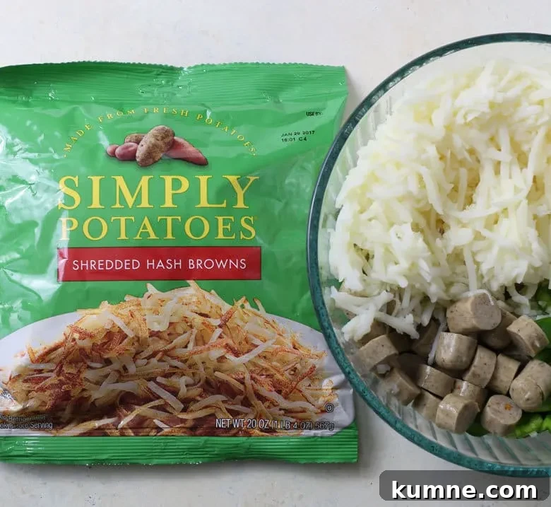 Mixing sausage, vegetables and hash browns in a bowl.