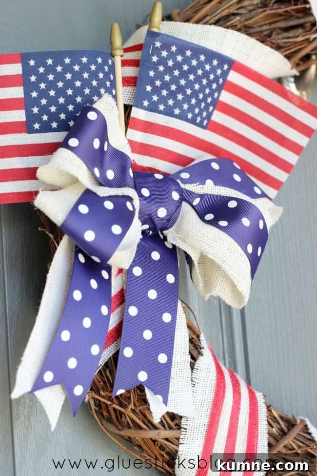 A gorgeous wreath to hang during the summer months! This patriotic wreath tutorial is simple to make, quick, and inexpensive! close up of bow on patriotic wreath