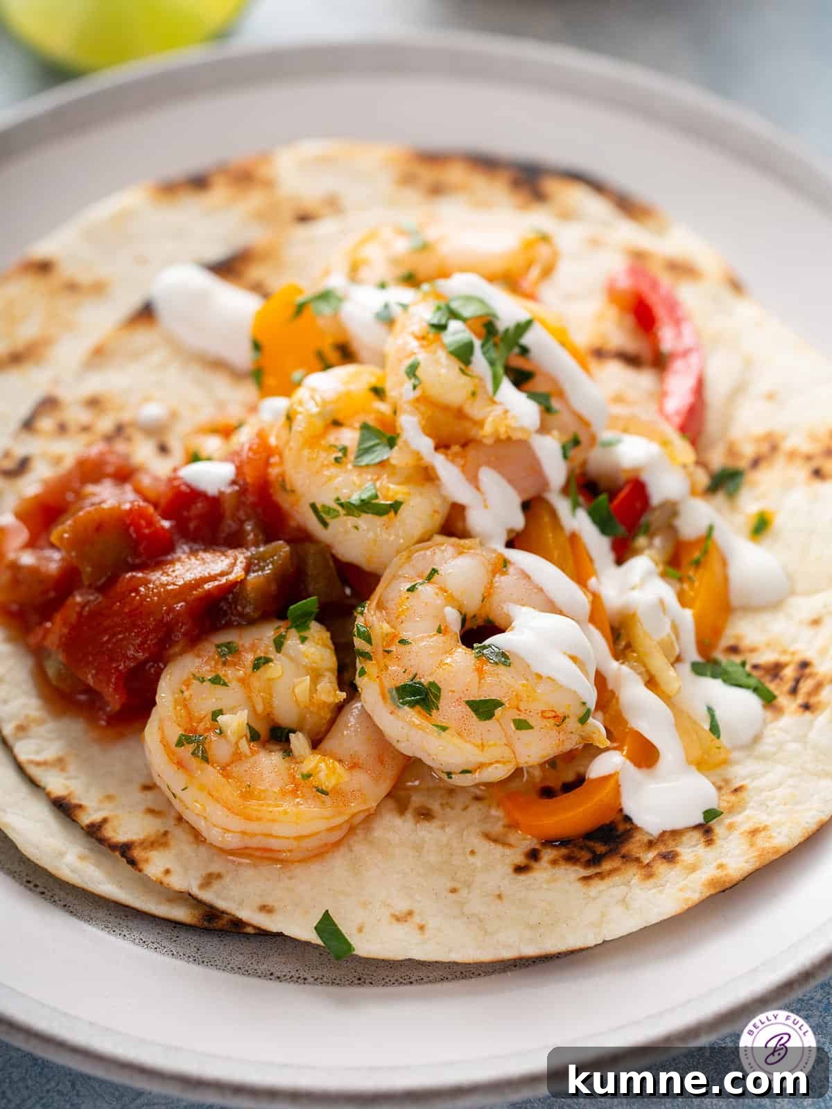 Sizzling Shrimp Fajitas Recipe for Quick Weeknight Dinner 9 Cooked shrimp on a toasted tortilla with sour cream drizzle and salsa