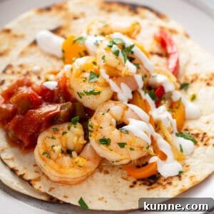 Sizzling Shrimp Fajitas Recipe for Quick Weeknight Dinner 3 sauteed shrimp on flour tortilla with sour cream and salsa