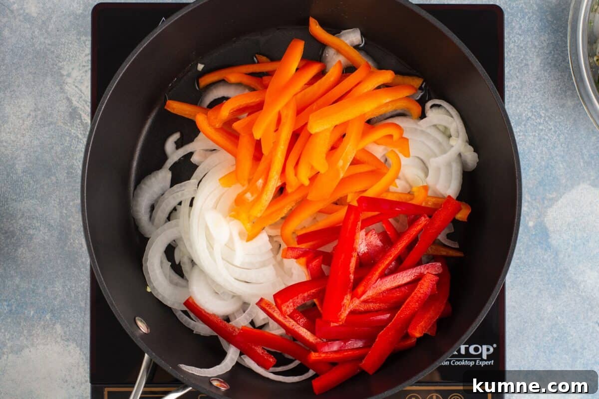 Sizzling Shrimp Fajitas Recipe for Quick Weeknight Dinner 6 Cooking peppers and onions in a skillet.