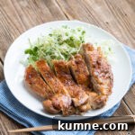 teriyaki chicken on a white plate with cabbage slaw