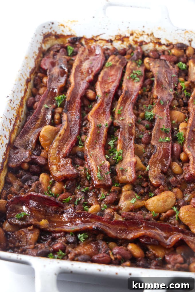 Smoky Cowboy Baked Beans Recipe with Bacon and Brown Sugar 2 Cowboy baked beans fresh out of the oven with bacon on top.