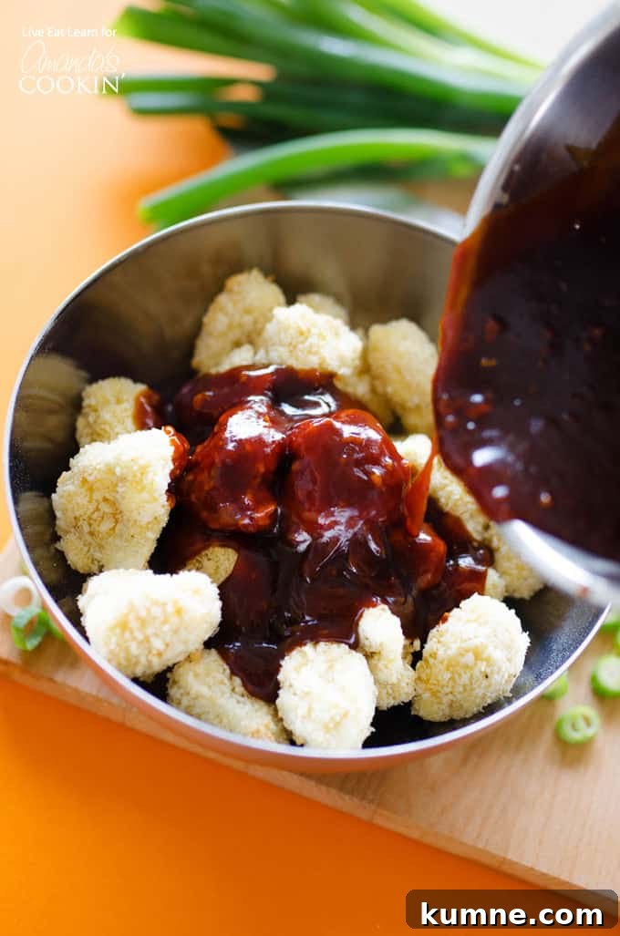 General Tso’s Cauliflower recipe Mixing sauce with breaded cauliflower