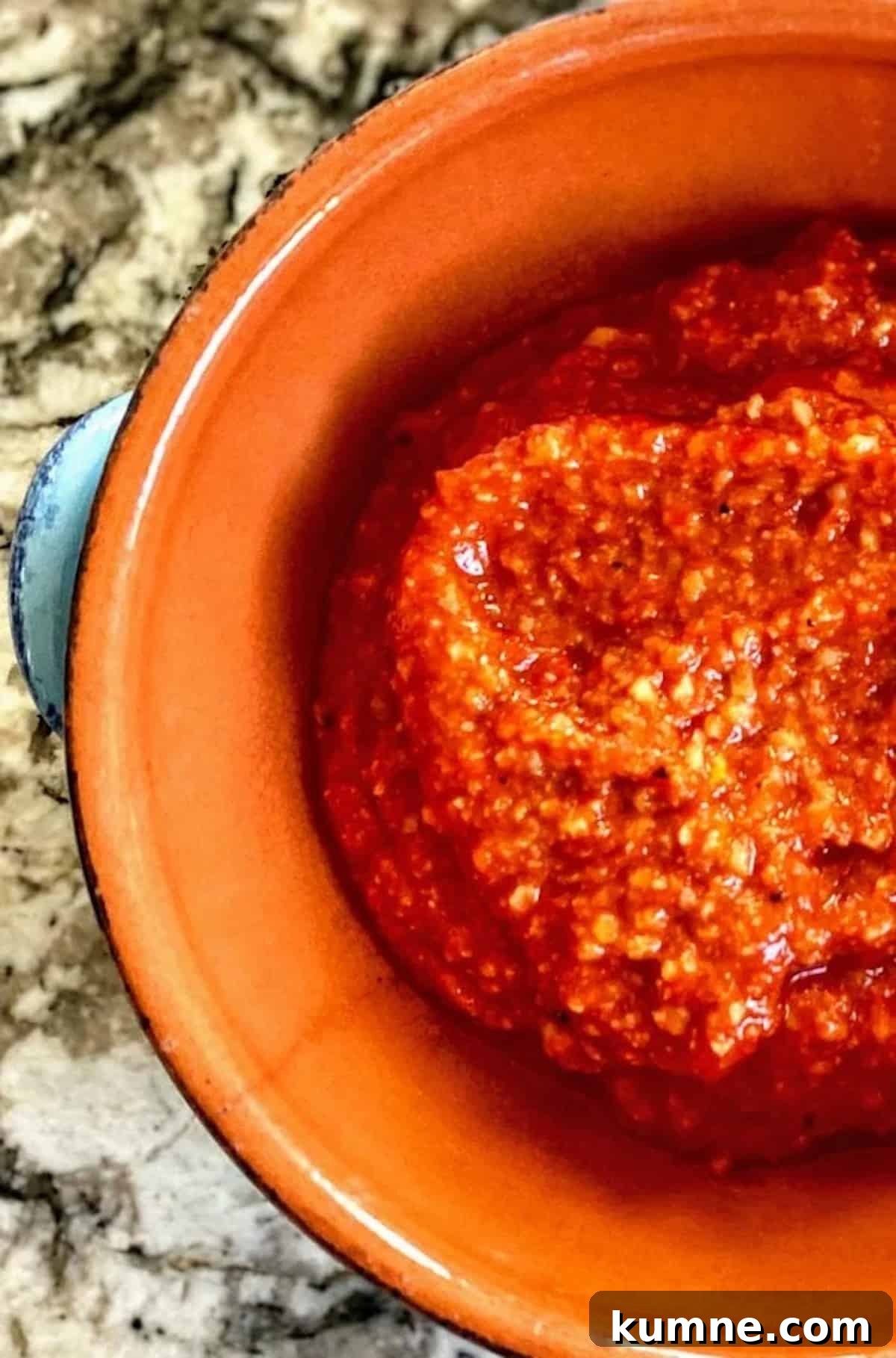 The sauce is in a bowl on the table. 
