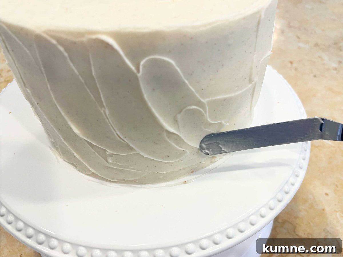 Ultimate Cinnamon Cake Recipe for Moist, Spiced Perfection 4 Adding texture to cake with a small rounded spatula.