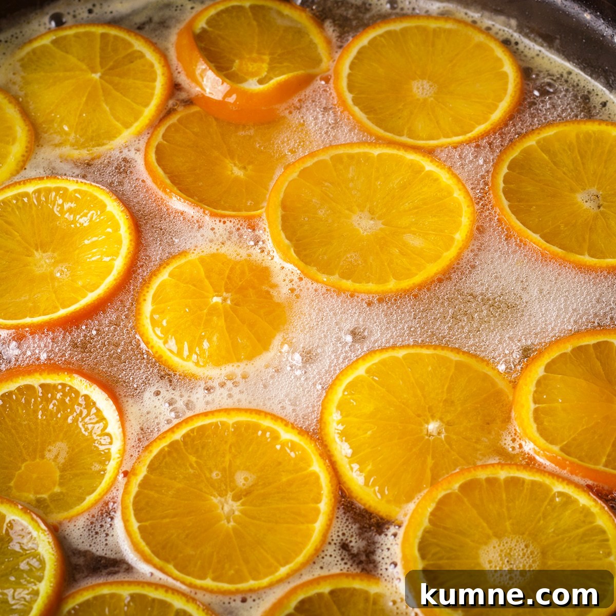Orange slices simmering in simple syrup.