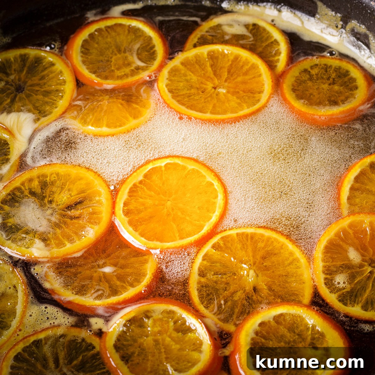 Orange slices simmering in simple syrup.