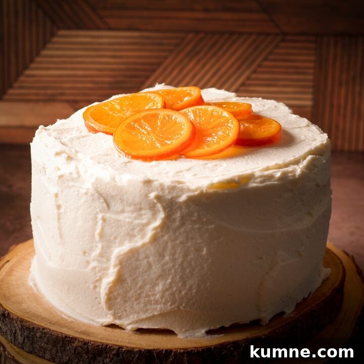 An orange olive oil cake covered in mascarpone frosting and decorated with candied oranges.
