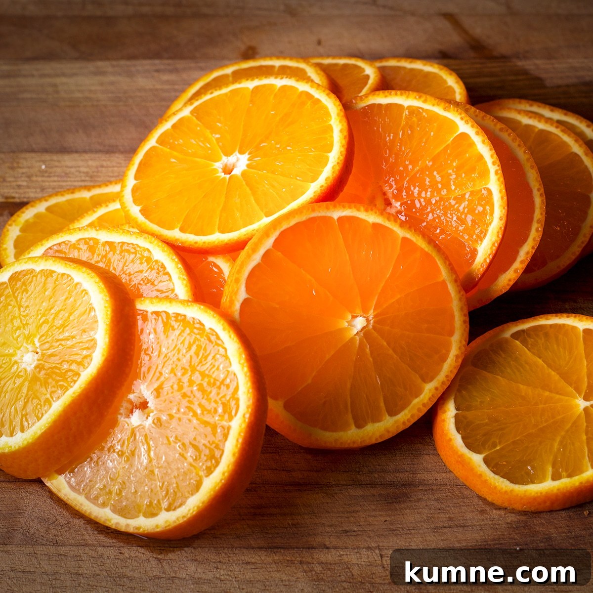 Slices of orange on a wood cutting board.