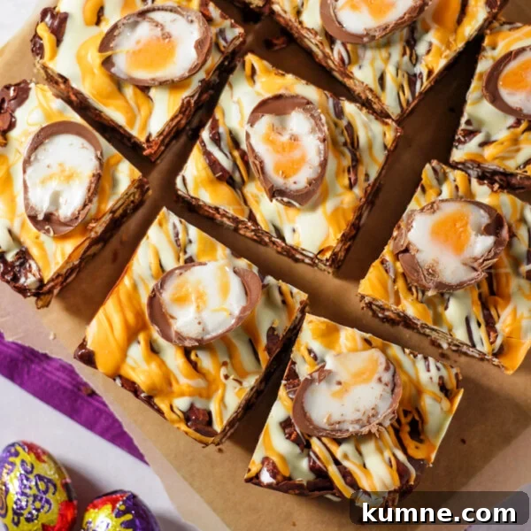 No-Bake Creme Egg Cheesecake Recipe for Spring Treat 6 Pieces of creme egg rocky road chocolate squares on chopping board.