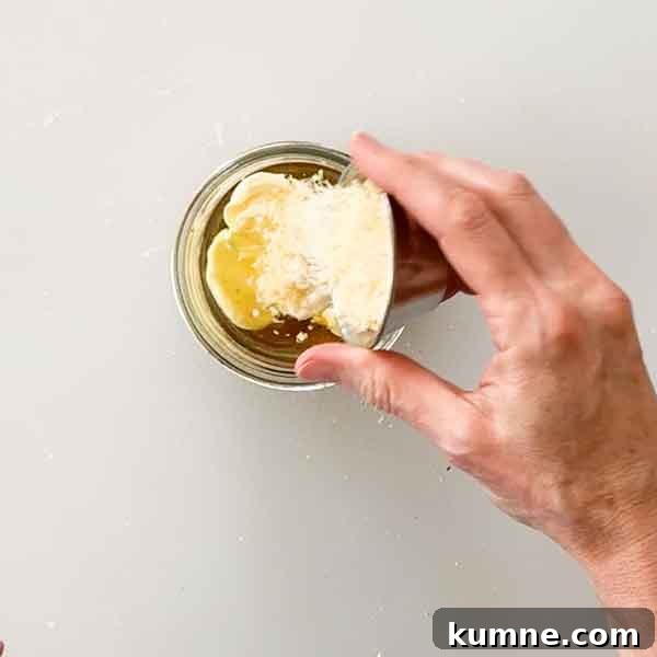 Olive Garden Creamy Italian Dressing Copycat Recipe — Quick Guide 5 Adding parmesan cheese to dressing.