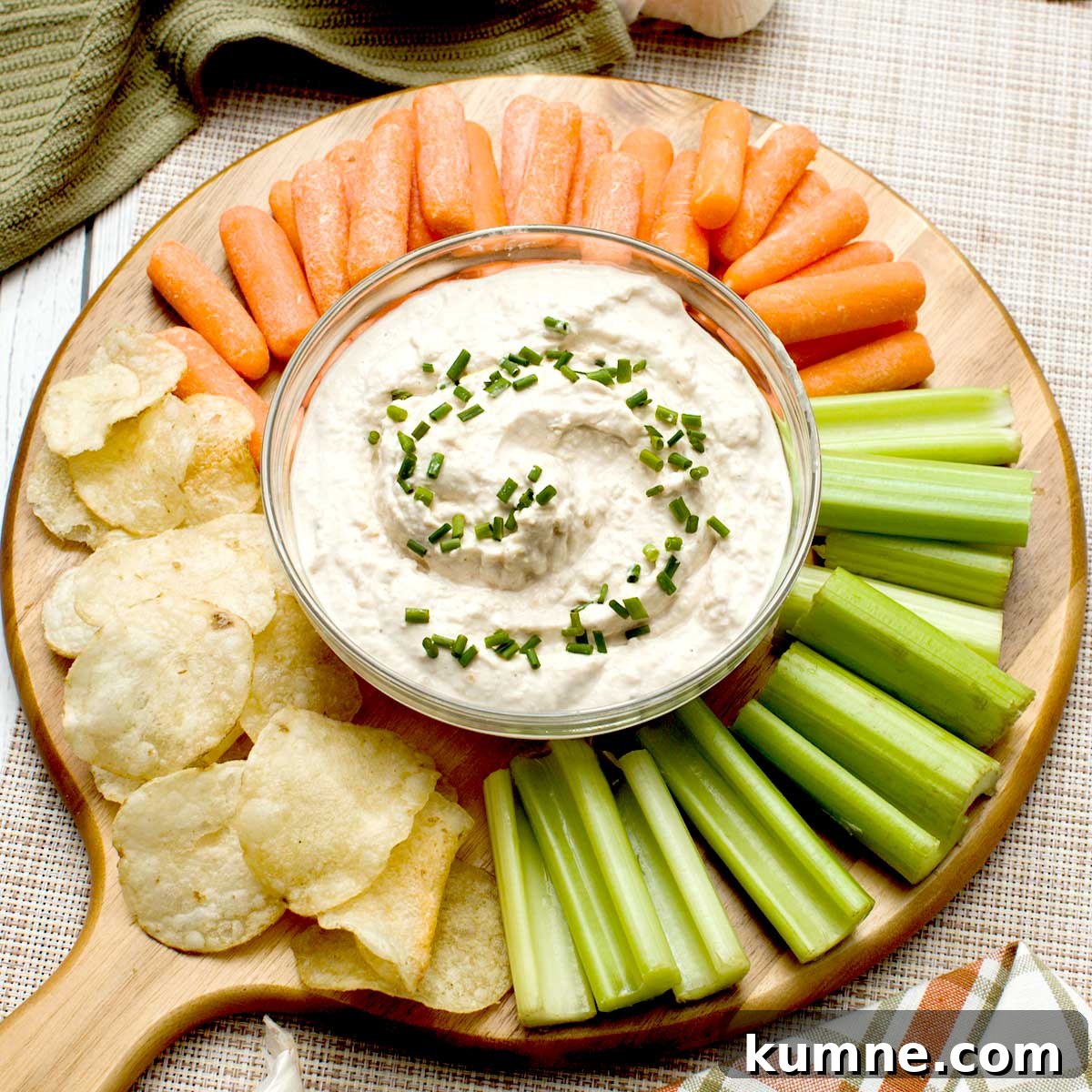 Olive Garden Creamy Italian Dressing Copycat Recipe — Quick Guide 8 A bowl of french onion dip with greek yogurt surrounded by cut veggies and potato chips.