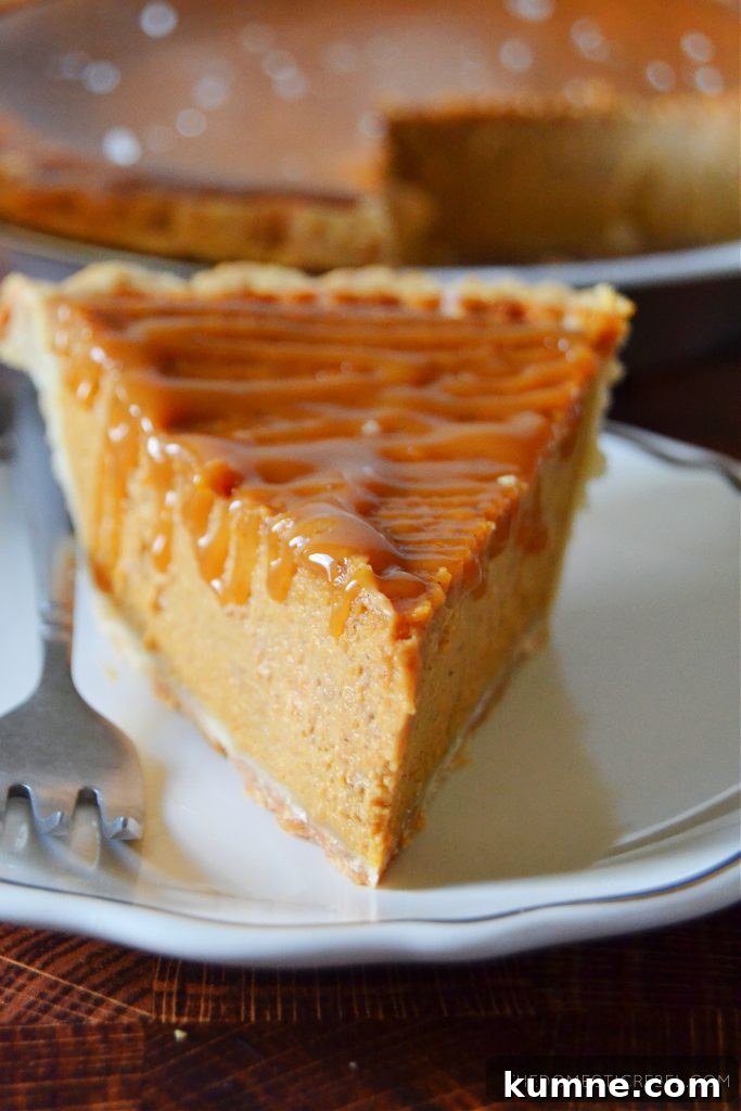 Salted Caramel Pumpkin Pie Recipe for Fall Desserts 3 a closeup shot of a slice of salted caramel pumpkin pie on a white plate