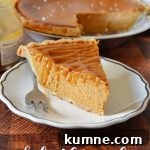 Salted Caramel Pumpkin Pie Recipe for Fall Desserts 6 a piece of salted caramel pumpkin pie on a small white plate with a silver fork