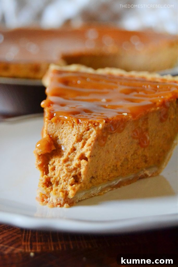 closeup of a salted caramel pumpkin pie with a bite missing