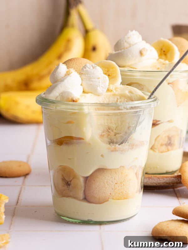High protein banana pudding layered in a jar with whipped cream.
