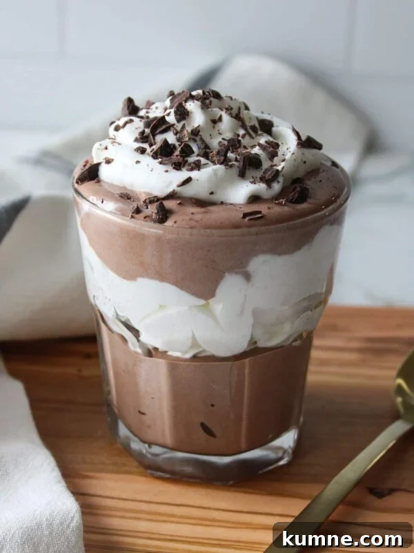 Cottage cheese chocolate mousse layered with whipped cream in a glass.