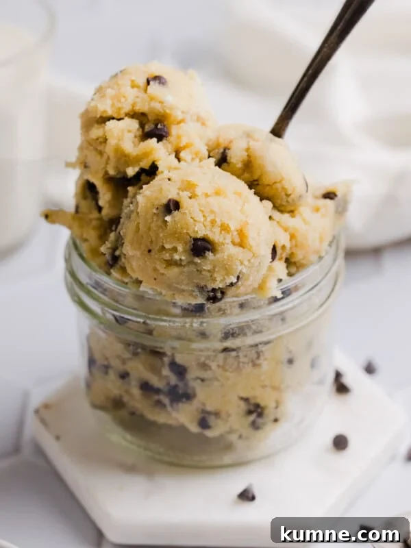 Cottage cheese cookie dough scooped into a mason jar with a spoon.