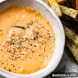 Homemade Chipotle Mayo Recipe for Creamy Spicy Sandwich Spread 2 Saucer of chipotle mayo garnished with herbs and surrounded by fries.