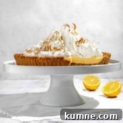 Lemon Meringue Pie with a Crispy Biscuit Crust 7 Biscuit base lemon meringue pie on a cake stand.