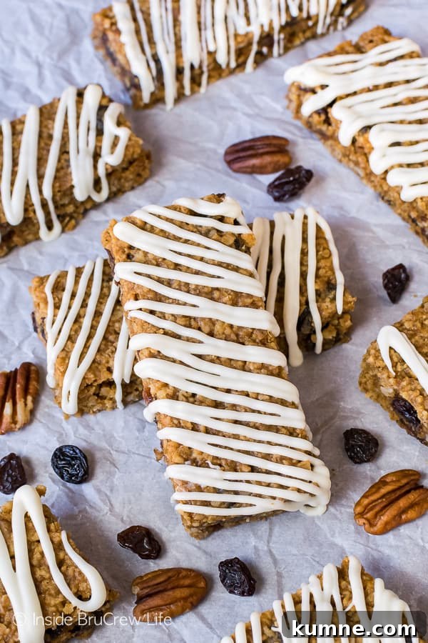 Overhead picture of gingerbread oatmeal bars drizzled with white chocolate on a white background