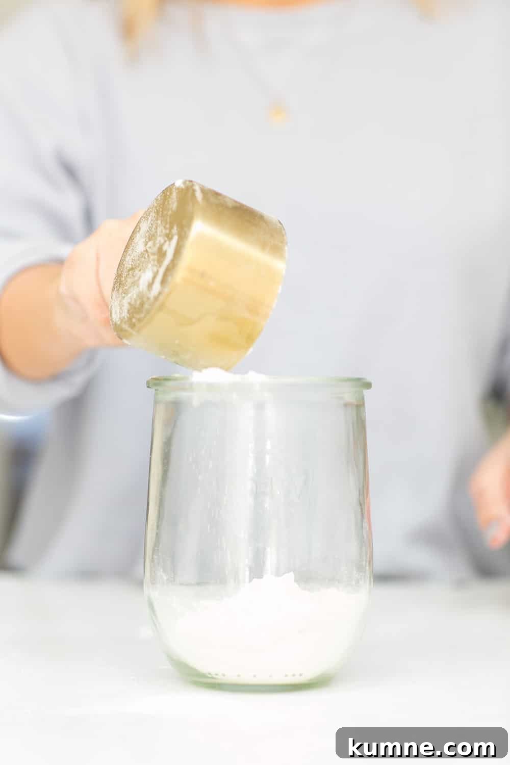 pouring flour into a jar