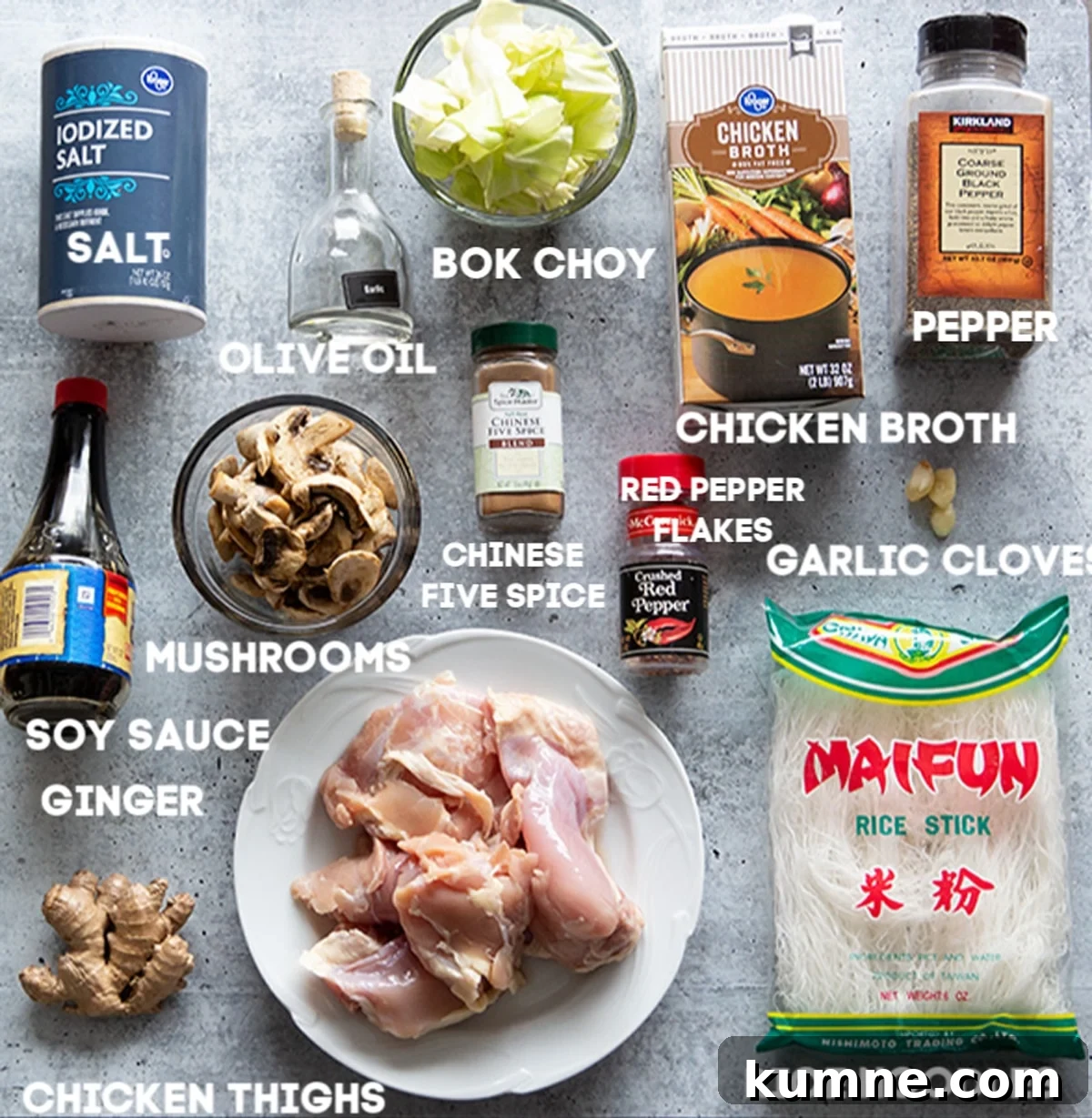 Authentic Asian Chicken Noodle Soup Recipe for Comforting Flavor 5 Chicken thighs, rice noodles, ginger, soy sauce, salt, olive oil, bok choy, chinese five spice, chicken broth and garlic on counter.