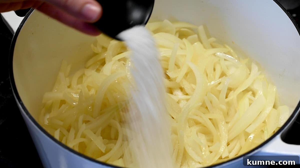 adding salt to onions