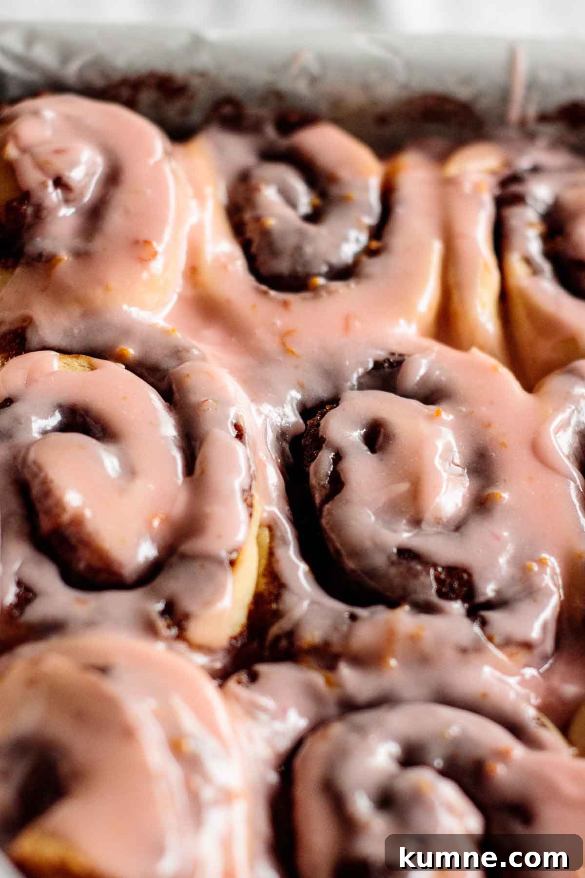 Pink Blood Orange Cinnamon Rolls with Zesty Glaze 2 Blood orange cinnamon rolls on a baking pan.