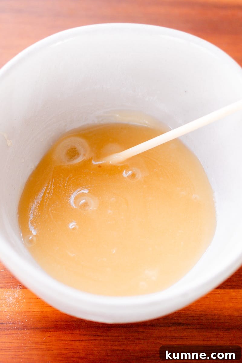 Baking Soda Face Mask: How to Make and Use It Safely 3 A homemade face mask using baking soda in a small white bowl.
