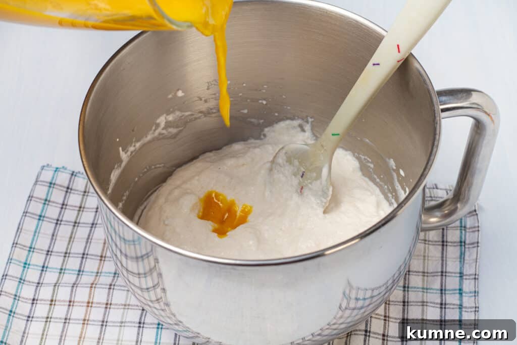 Creamy Mango Mousse Recipe: Light No-Bake Dessert in Minutes 5 mango pouring into mousse mixture