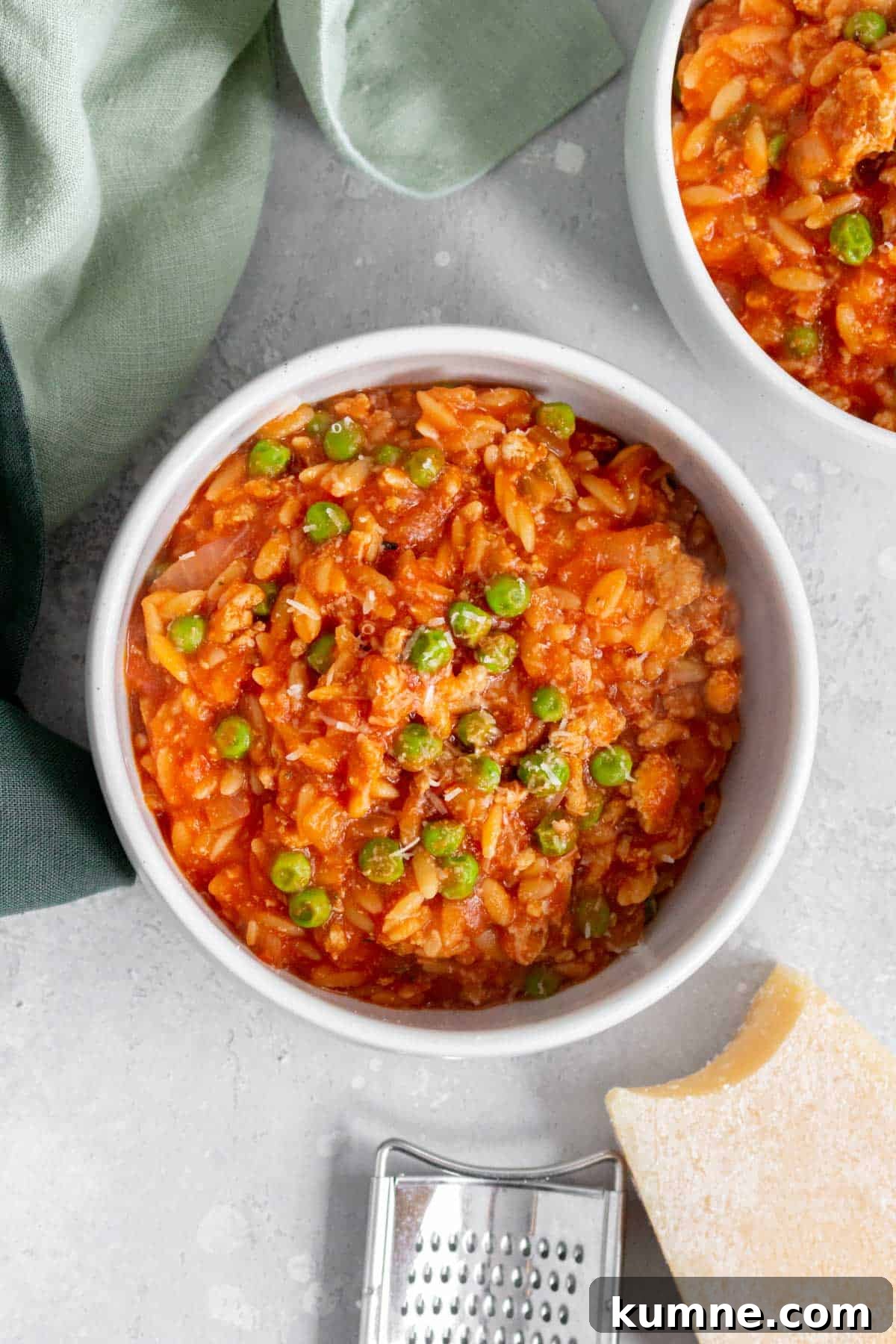 Overhead view of a bowl of one pot orzo with turkey and peas.